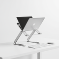 Adjustable aluminum laptop stand on a clean desk